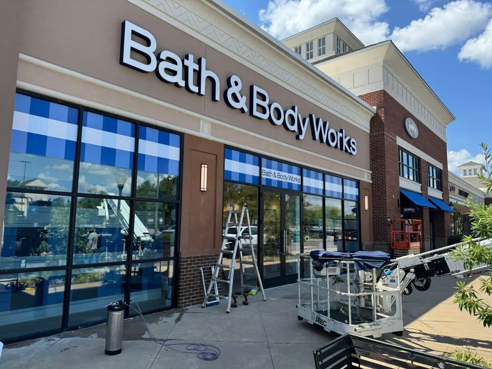 Bath & Body Works storefront with blue checkered design and maintenance equipment outside.