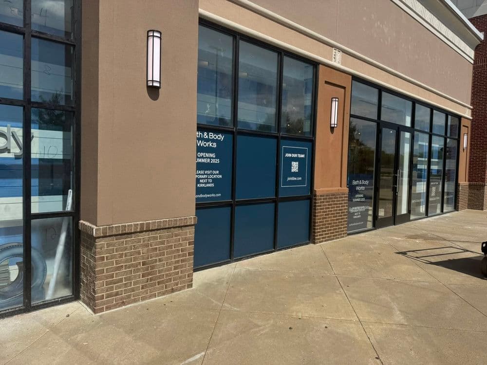 New Earth & Body Works storefront with signage indicating opening soon, brick and glass exterior.